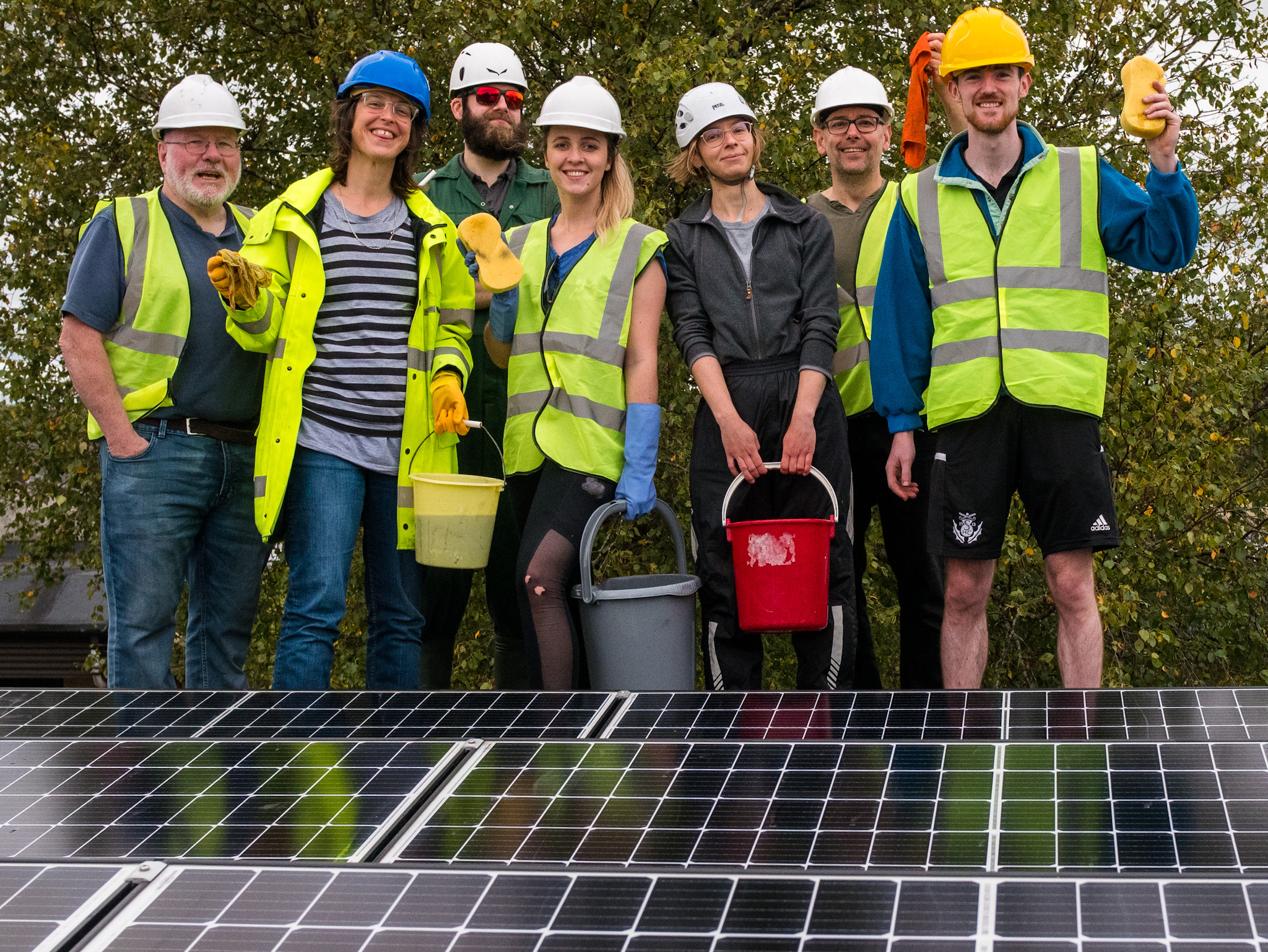 Members of the Board and other volunteers cleaning solar panels at Ashton Secondary School in September 2022